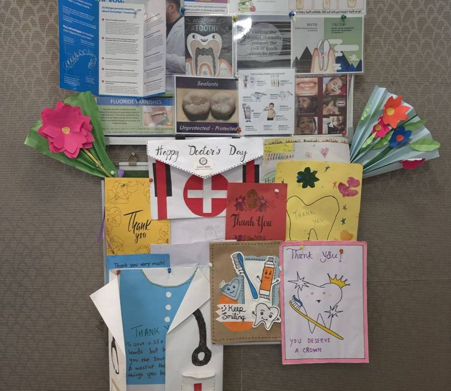 A wall of thank-you cards and drawings from Dr. Arjav Beswal's young patients