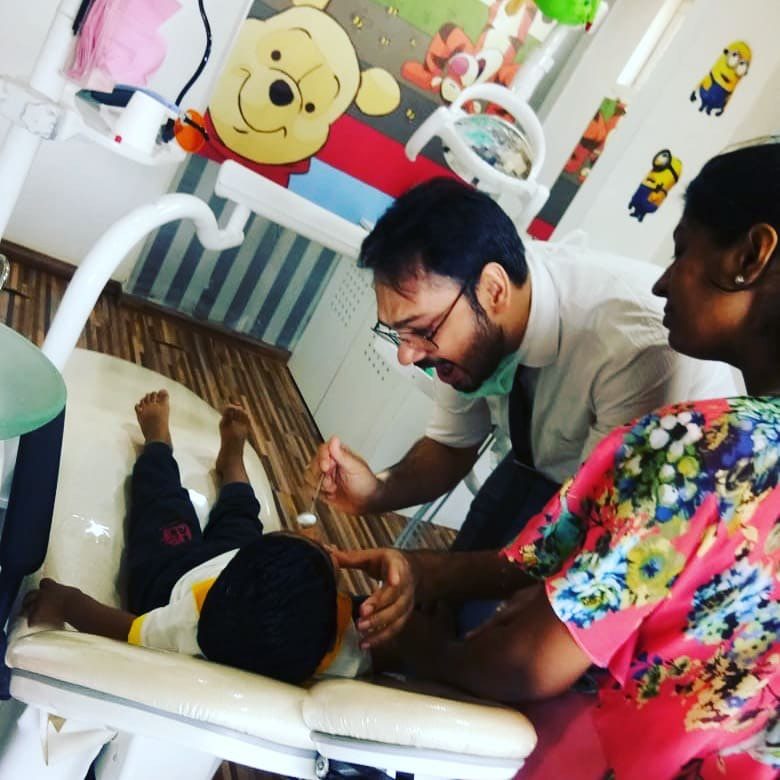 A child receiving gentle dental treatment at Dr. Arjav Beswal's clinic